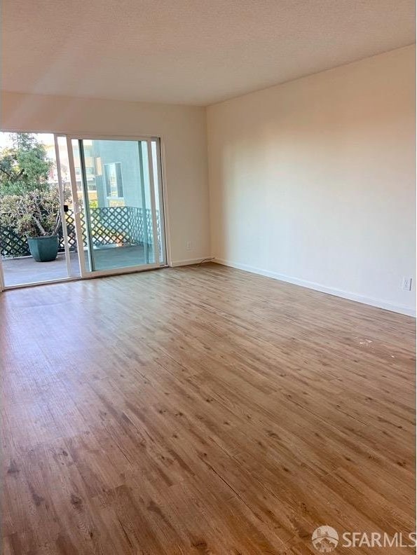 spare room with hardwood / wood-style flooring