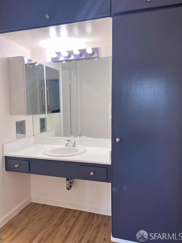 bathroom featuring sink and hardwood / wood-style floors