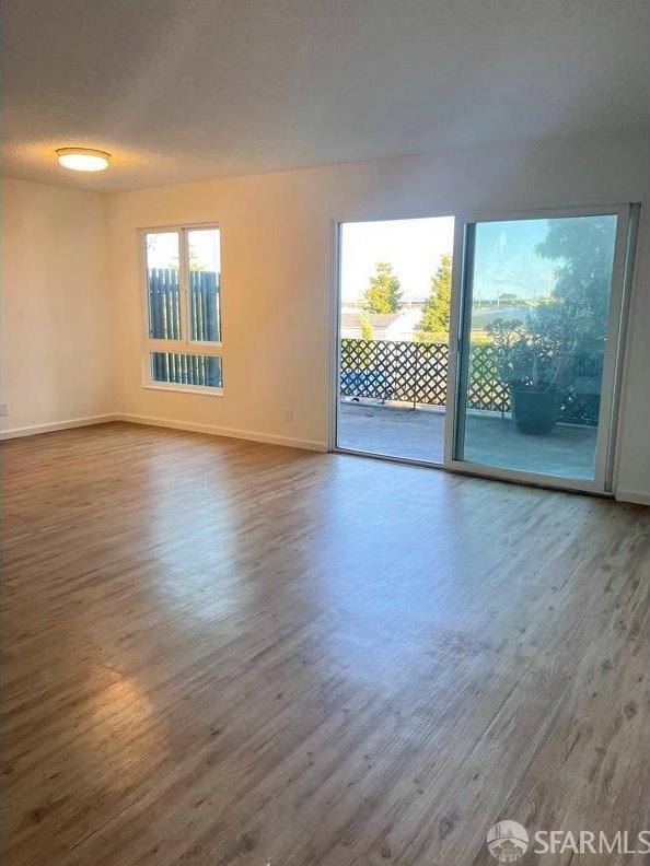 empty room featuring wood-type flooring