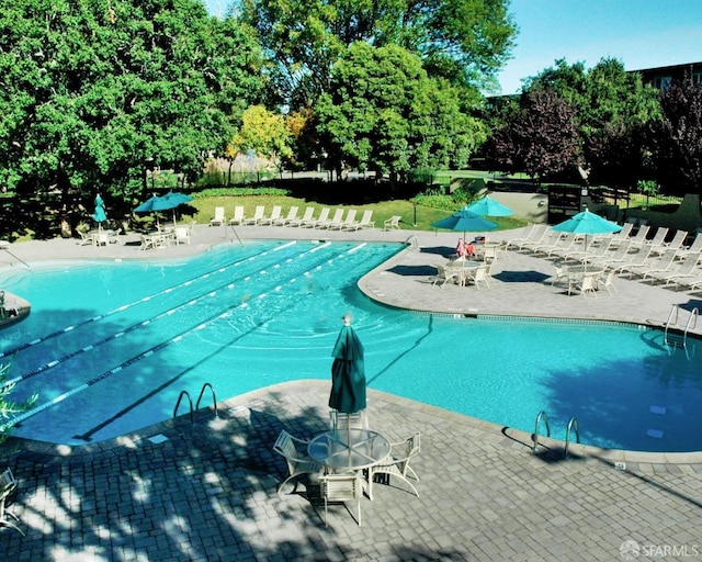 view of swimming pool featuring a patio