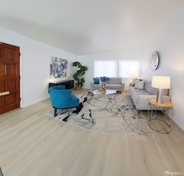 living room with light wood-type flooring and vaulted ceiling