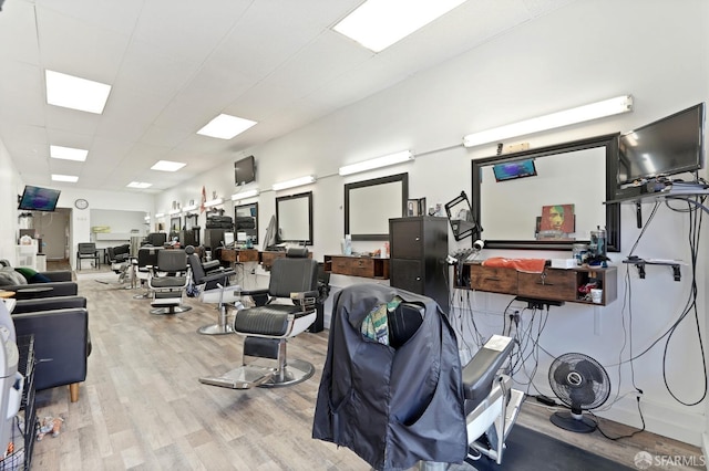 gym featuring a paneled ceiling and wood finished floors