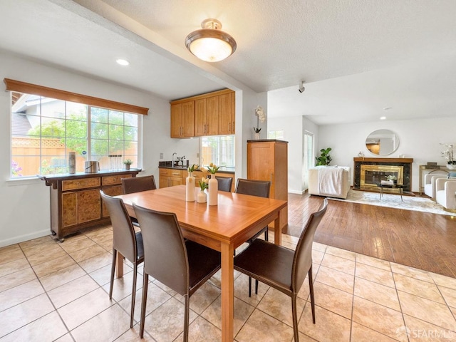 1113 Pebblewood Way, San Mateo, CA 94403 - dining room featuring light tile patterned floors, a fireplace, recessed lighting, and baseboards