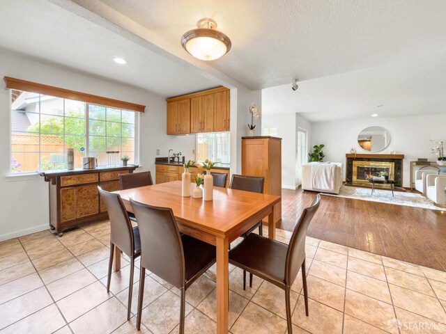 1113 Pebblewood Way, San Mateo, CA 94403 - dining space featuring light tile patterned floors, recessed lighting, a premium fireplace, and baseboards