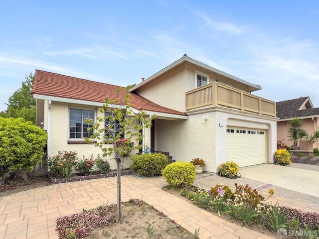 1113 Pebblewood Way, San Mateo, CA 94403 - view of front facade with an attached garage, driveway, stucco siding, and a balcony