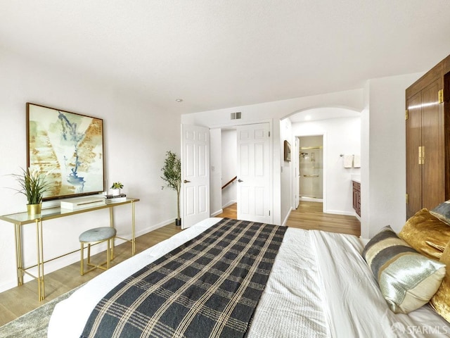1113 Pebblewood Way, San Mateo, CA 94403 - bedroom featuring baseboards, arched walkways, and wood finished floors