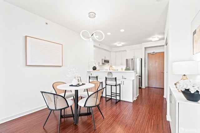 dining area featuring dark wood-style floors and baseboards