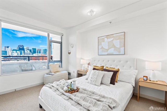 bedroom with carpet, a view of city, and baseboards