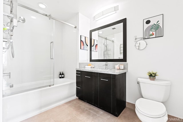 full bath with toilet, vanity, combined bath / shower with glass door, and tile patterned floors