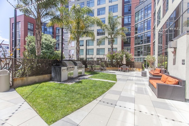 view of property's community with a patio, exterior kitchen, and a yard