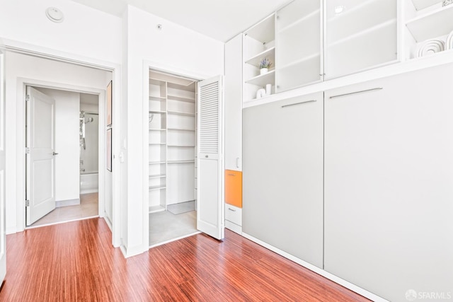 unfurnished bedroom featuring a closet and wood finished floors