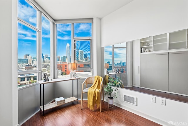 sunroom with a view of city and visible vents