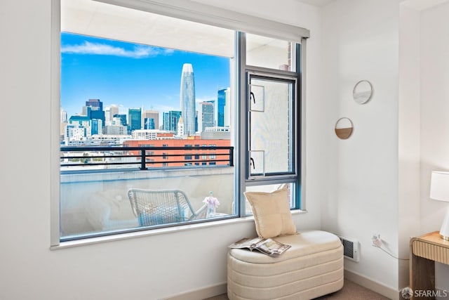 living area featuring visible vents, baseboards, and a city view