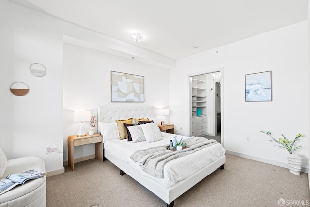 bedroom featuring light carpet and baseboards