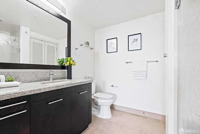 full bath with toilet, vanity, a walk in shower, tile patterned flooring, and baseboards