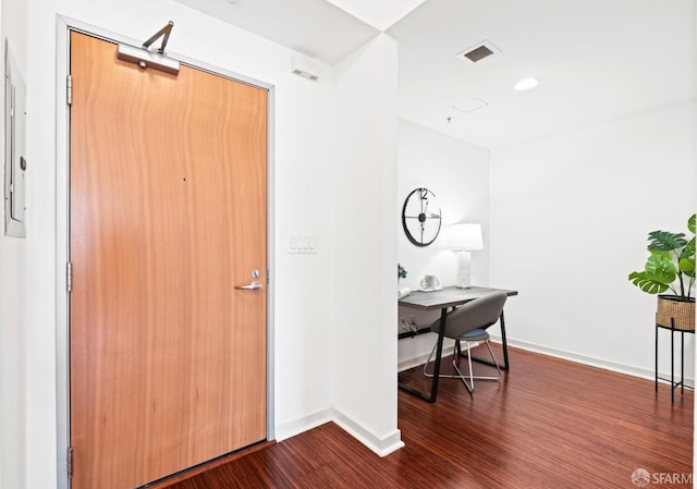 interior space with visible vents, baseboards, and dark wood-type flooring