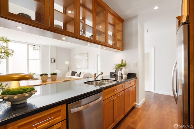 351 Buena Vista E Avenue 604E, San Francisco, CA 94117 - kitchen featuring appliances with stainless steel finishes, brown cabinetry, light wood-style floors, glass insert cabinets, and recessed lighting