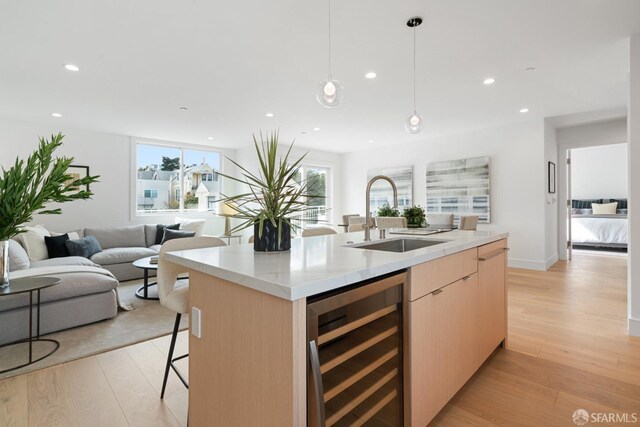 350 San Jose Ave Unit 11, San Francisco, CA 94110 - kitchen featuring light brown cabinetry, modern cabinets, light wood-type flooring, a sink, and wine cooler
