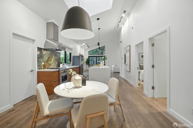 206 Donohoe St, East Palo Alto, CA 94303 - dining area with light wood-type flooring and high vaulted ceiling