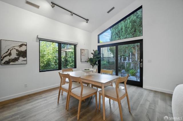 206 Donohoe St, East Palo Alto, CA 94303 - dining space with rail lighting, high vaulted ceiling, and wood finished floors