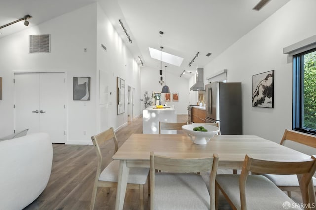 206 Donohoe St, East Palo Alto, CA 94303 - dining space with track lighting, wood finished floors, a skylight, and high vaulted ceiling