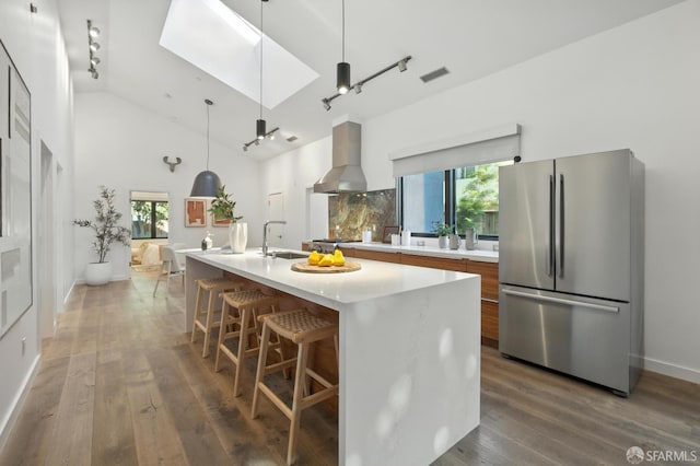 206 Donohoe St, East Palo Alto, CA 94303 - kitchen with appliances with stainless steel finishes, wall chimney range hood, modern cabinets, light countertops, and rail lighting