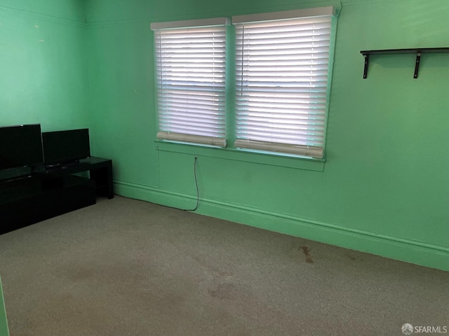 interior space with plenty of natural light and light colored carpet