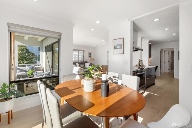 dining room with hardwood / wood-style floors and ornamental molding