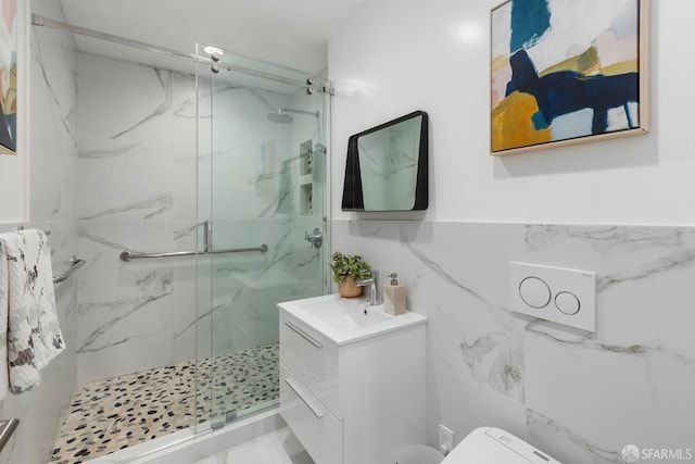 bathroom featuring vanity, an enclosed shower, tile walls, and toilet