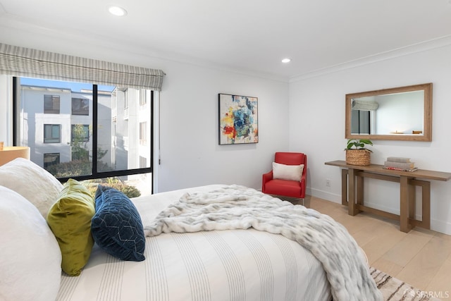 bedroom with light hardwood / wood-style flooring and ornamental molding