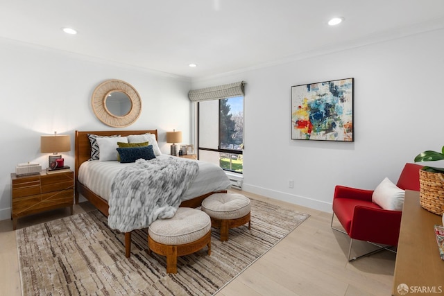 bedroom featuring ornamental molding and light wood-type flooring