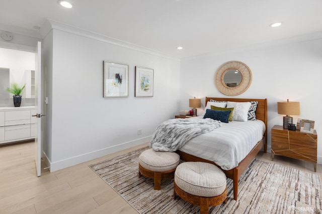 bedroom featuring light hardwood / wood-style flooring and ornamental molding