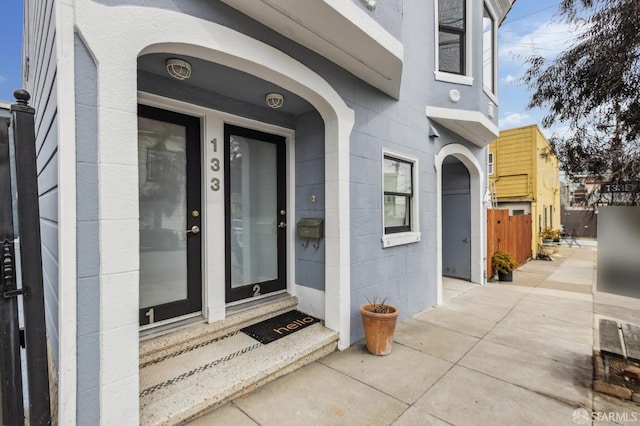 view of exterior entry featuring concrete block siding