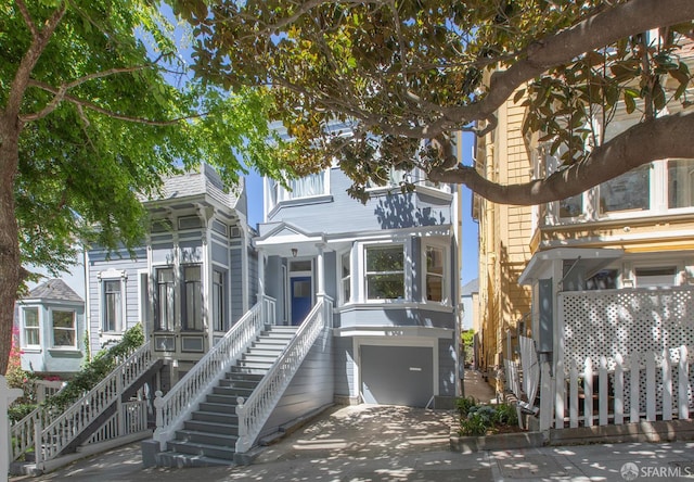 213 Virginia Ave, San Francisco, CA 94110 - view of front of home with stairway, a garage, and concrete driveway