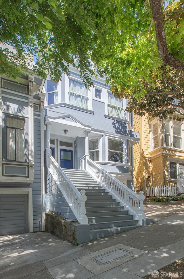213 Virginia Ave, San Francisco, CA 94110 - view of front of property featuring stairs, a porch, and an attached garage