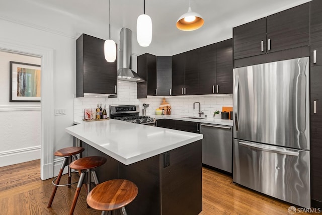 213 Virginia Ave, San Francisco, CA 94110 - kitchen with stainless steel appliances, wall chimney range hood, a kitchen breakfast bar, tasteful backsplash, and light countertops
