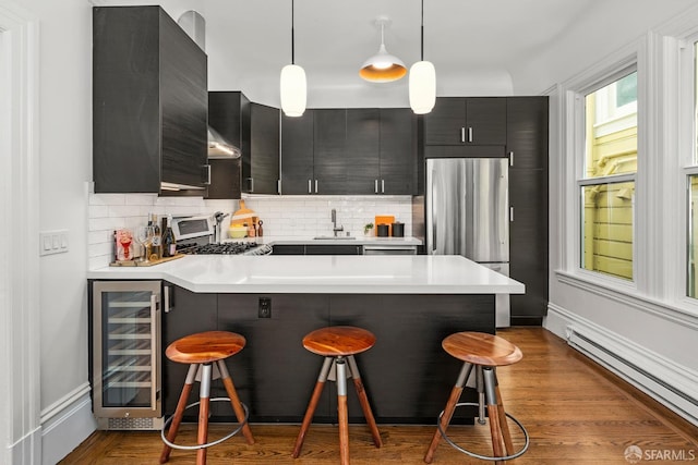 213 Virginia Ave, San Francisco, CA 94110 - kitchen featuring beverage cooler, freestanding refrigerator, a baseboard radiator, a kitchen breakfast bar, and a sink