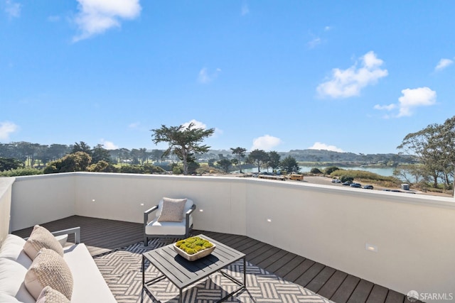 wooden terrace featuring a water view