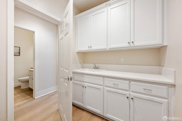 washroom featuring sink and light hardwood / wood-style floors