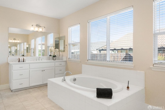 bathroom with vanity, tiled bath, and tile patterned floors