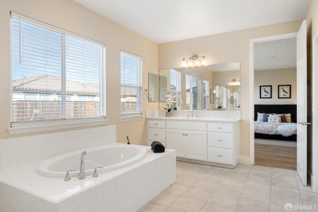 bathroom with vanity, tile patterned floors, and tiled bath