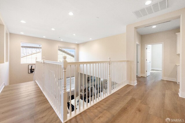 corridor with light hardwood / wood-style flooring