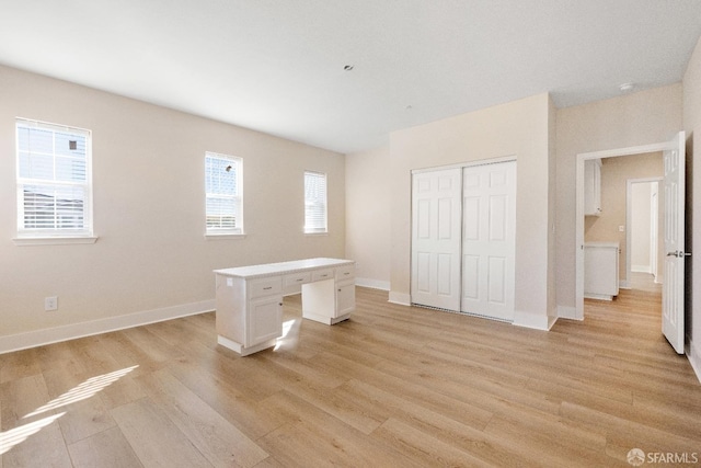 unfurnished bedroom featuring light hardwood / wood-style floors and a closet