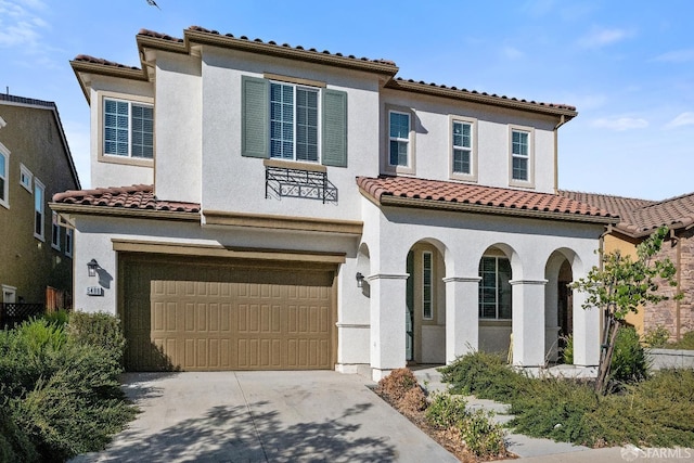 mediterranean / spanish house featuring a garage