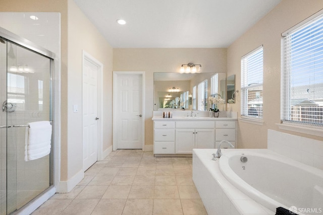 bathroom featuring tile patterned flooring, plus walk in shower, and vanity