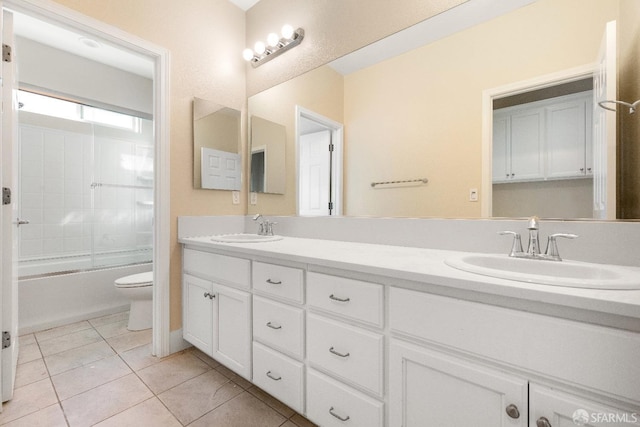 full bathroom with toilet, tile patterned flooring, vanity, and enclosed tub / shower combo