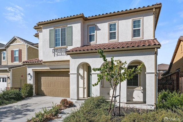 mediterranean / spanish-style house featuring a garage