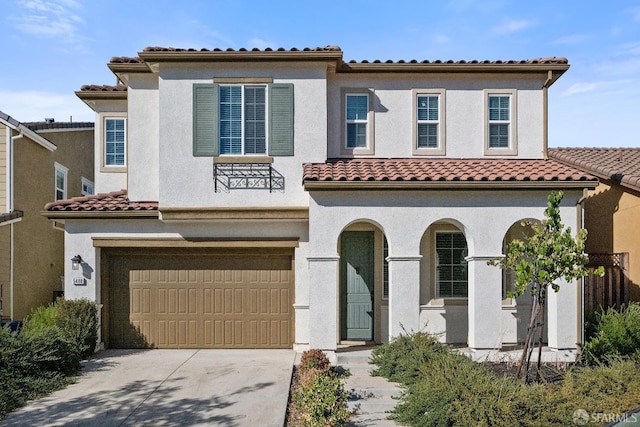 mediterranean / spanish house featuring a garage