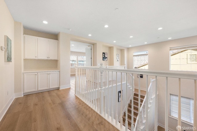 corridor with light hardwood / wood-style floors