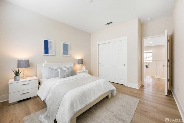 bedroom featuring light hardwood / wood-style flooring and a closet